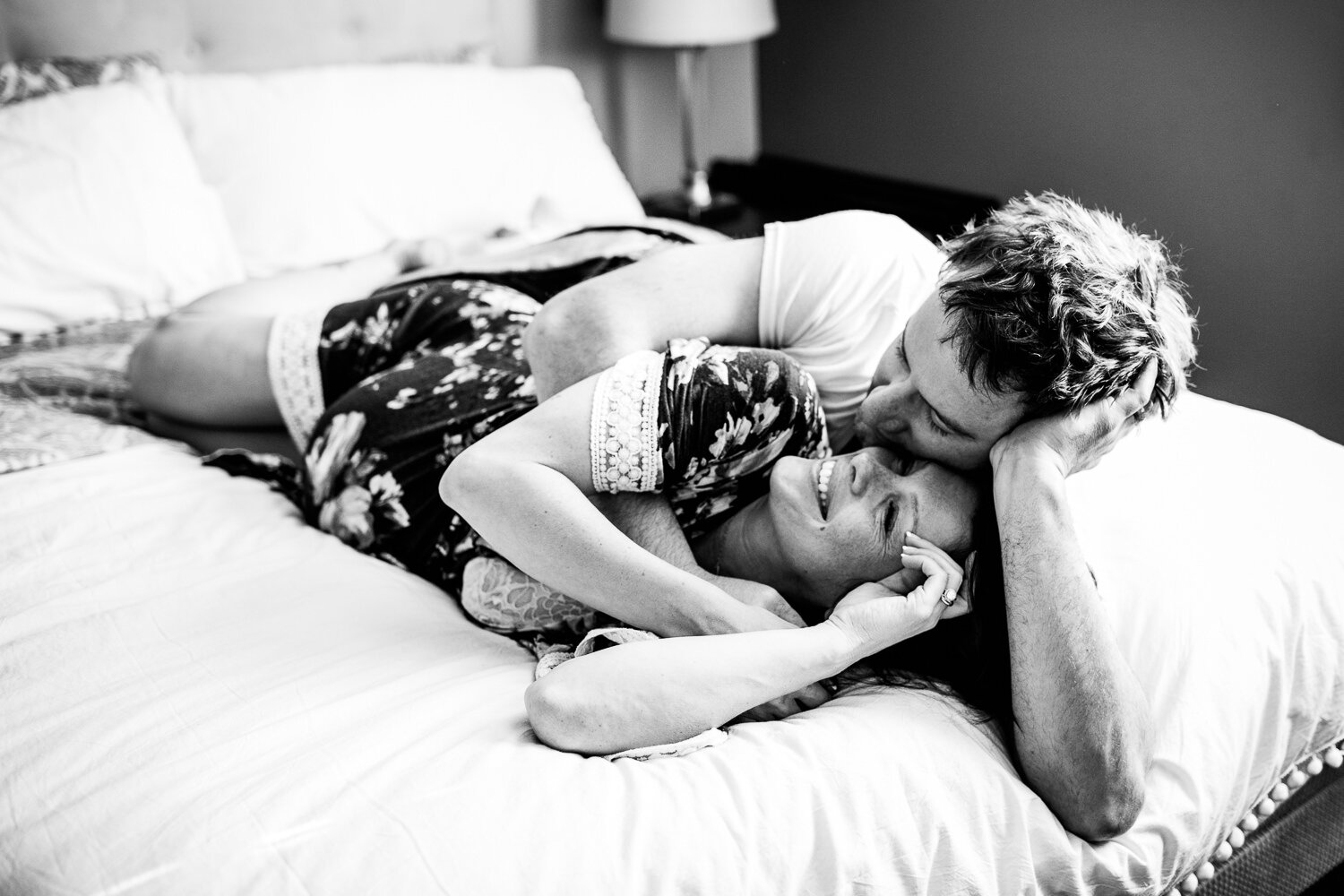 Black and white of couple laying in bed