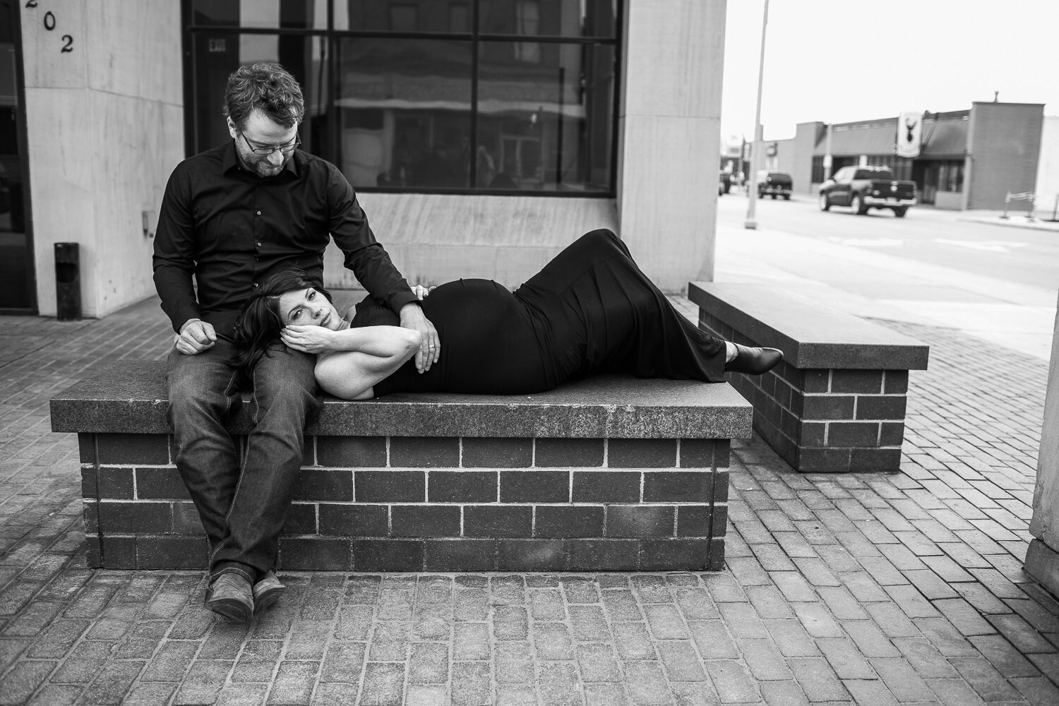 Couple one a bench in black and white
