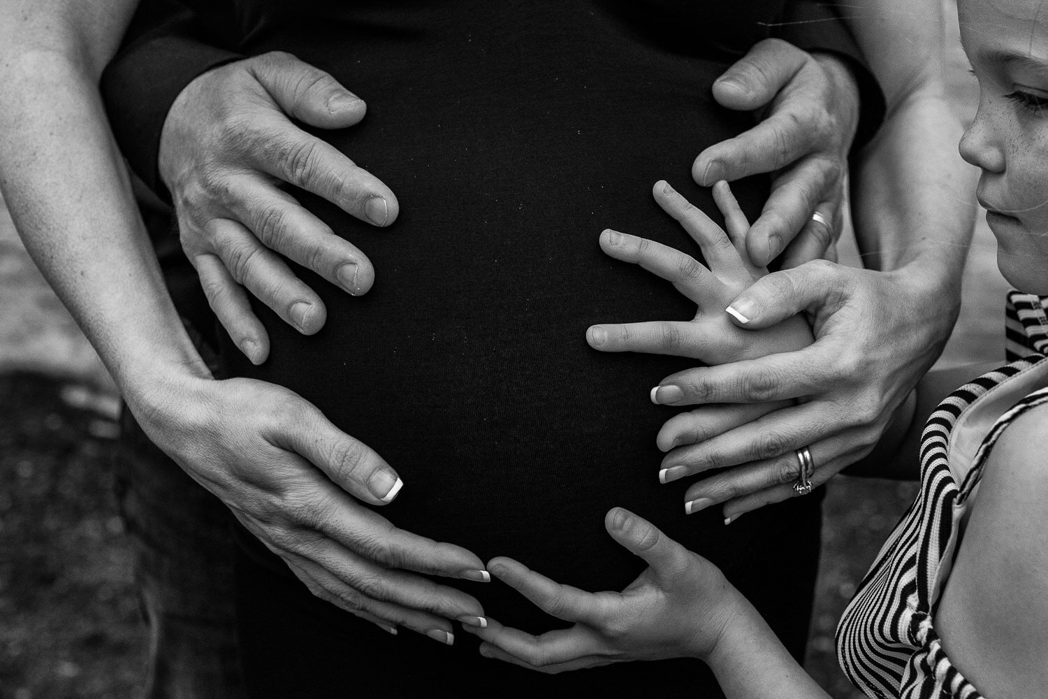 Detail shot of hands on pregnant belly