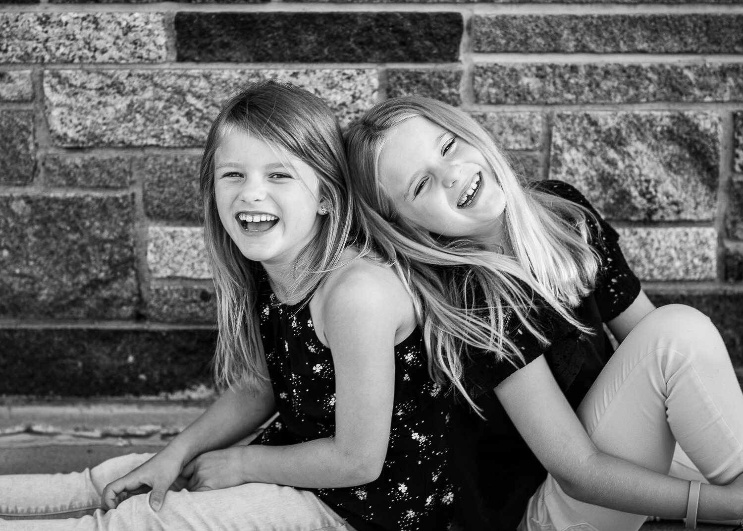 Black and white of twins laughing 