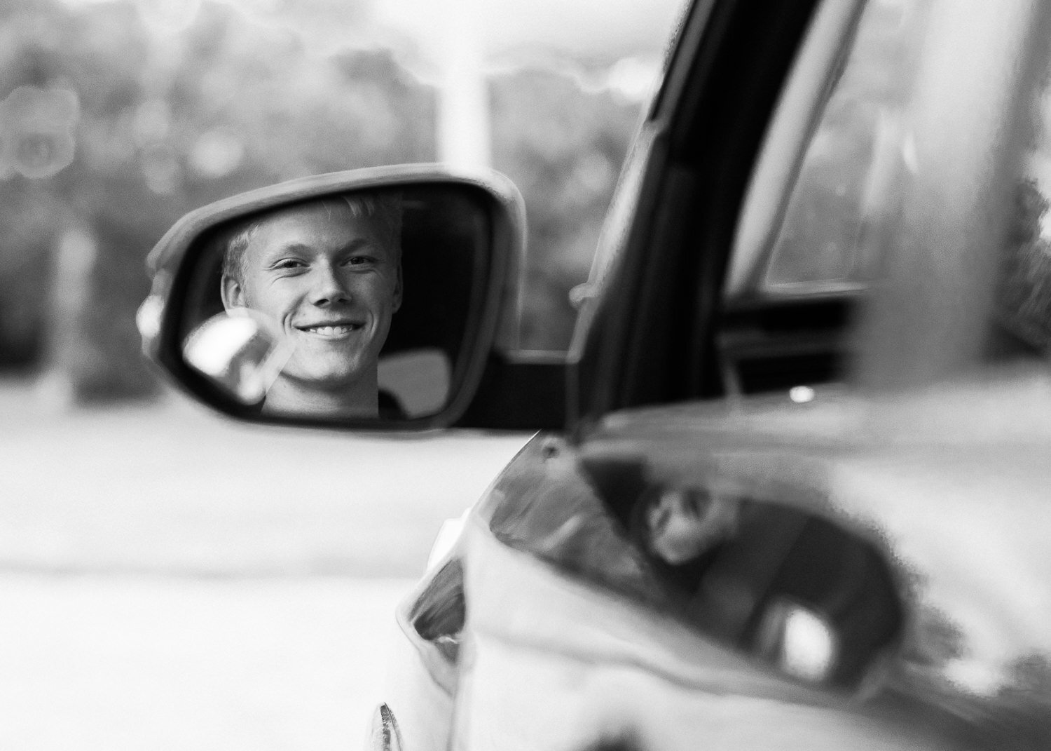 Senior boy in rear view mirror