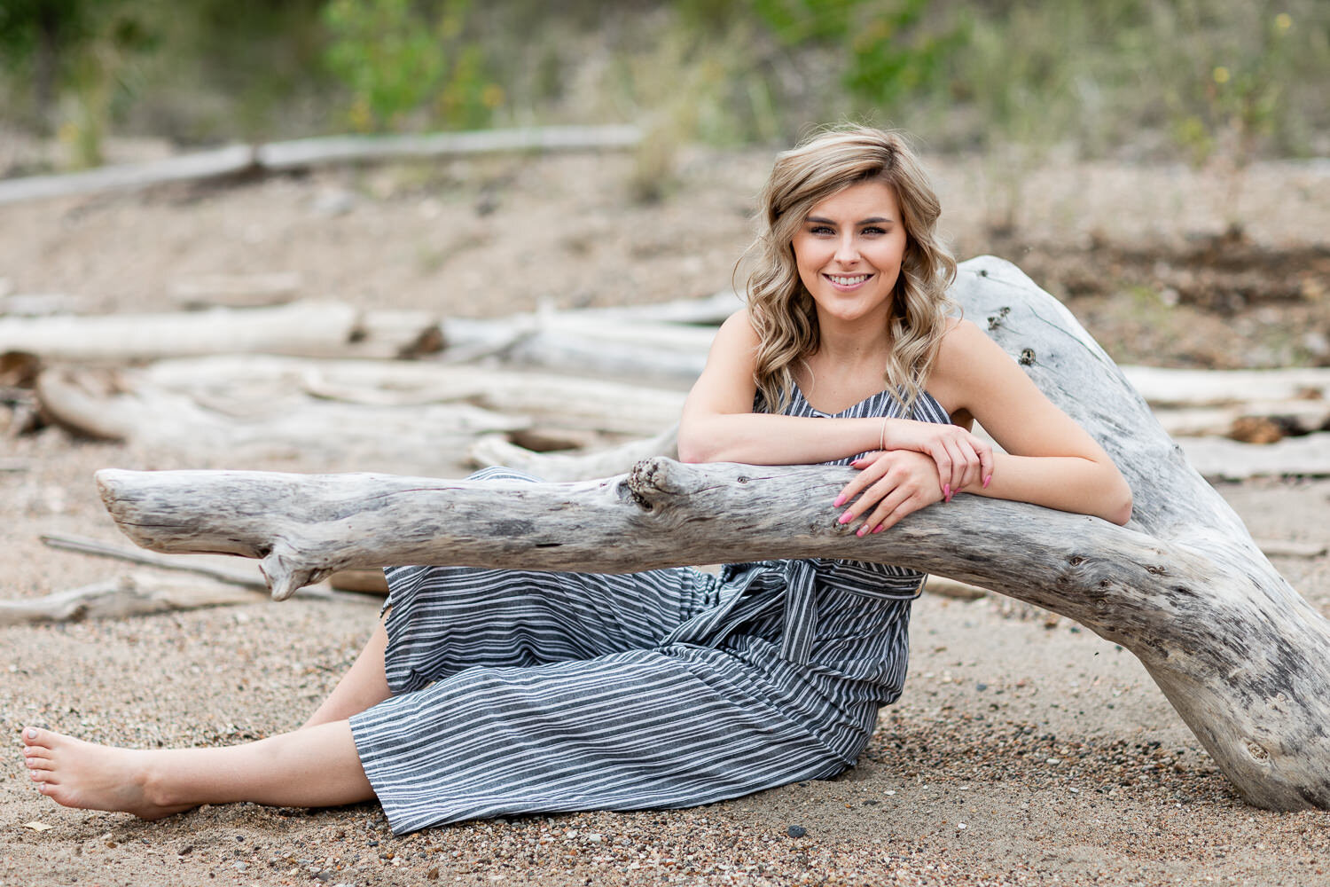 Senior girl leaning on a log