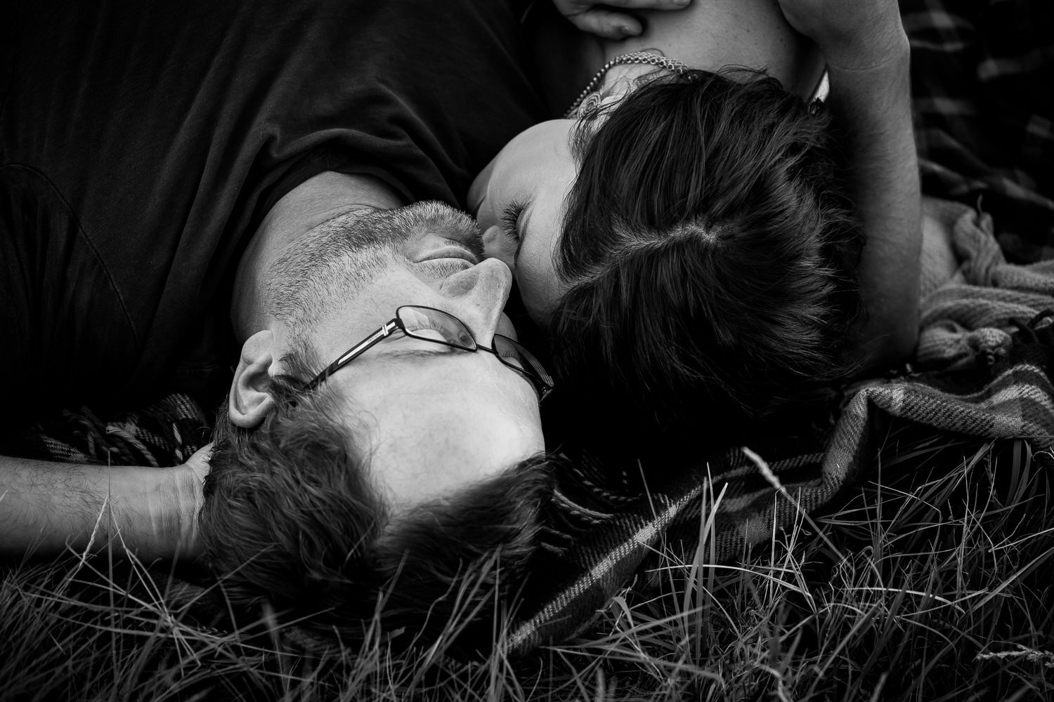 Black and white of couple laying down 