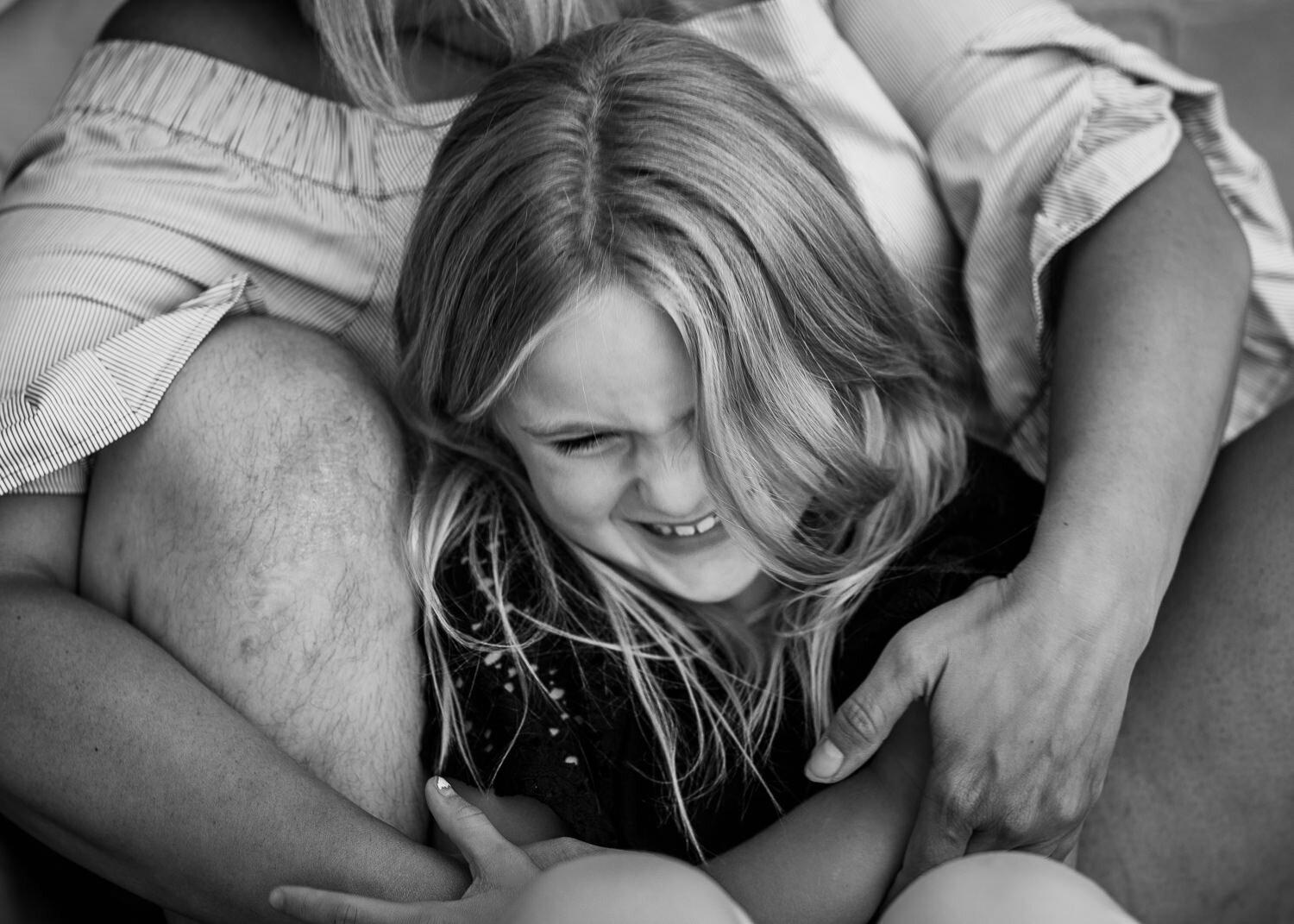 Black and white of daughter giggling 
