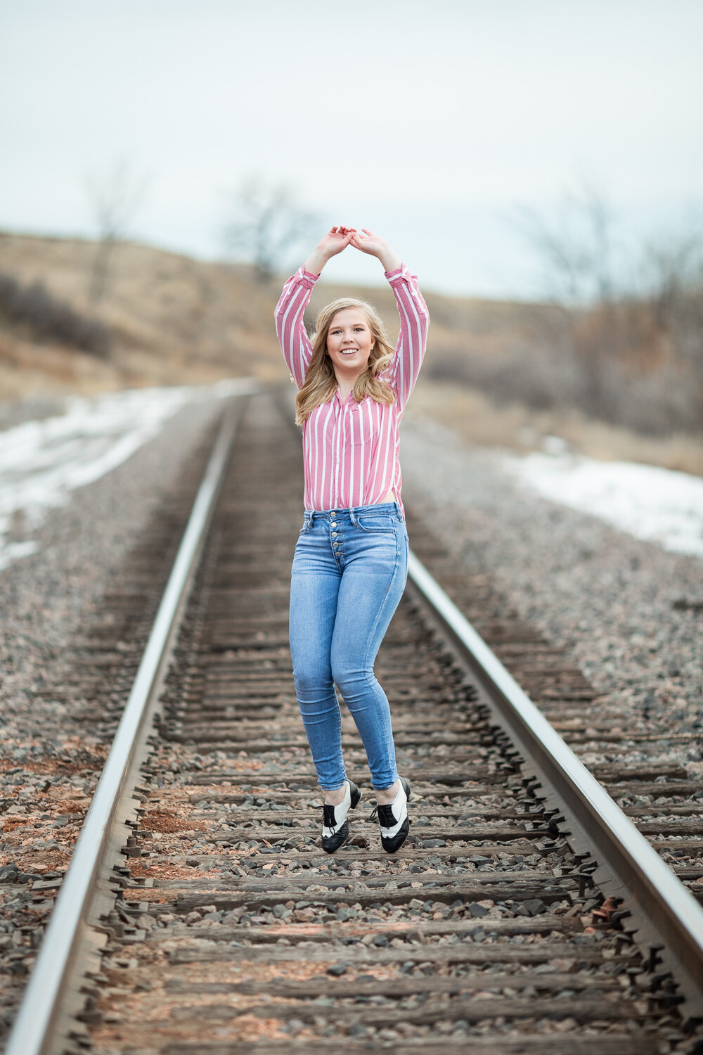senior girl on train tracks