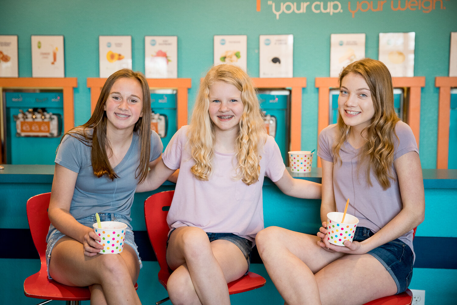3 teen girls in front of yogurt machine 