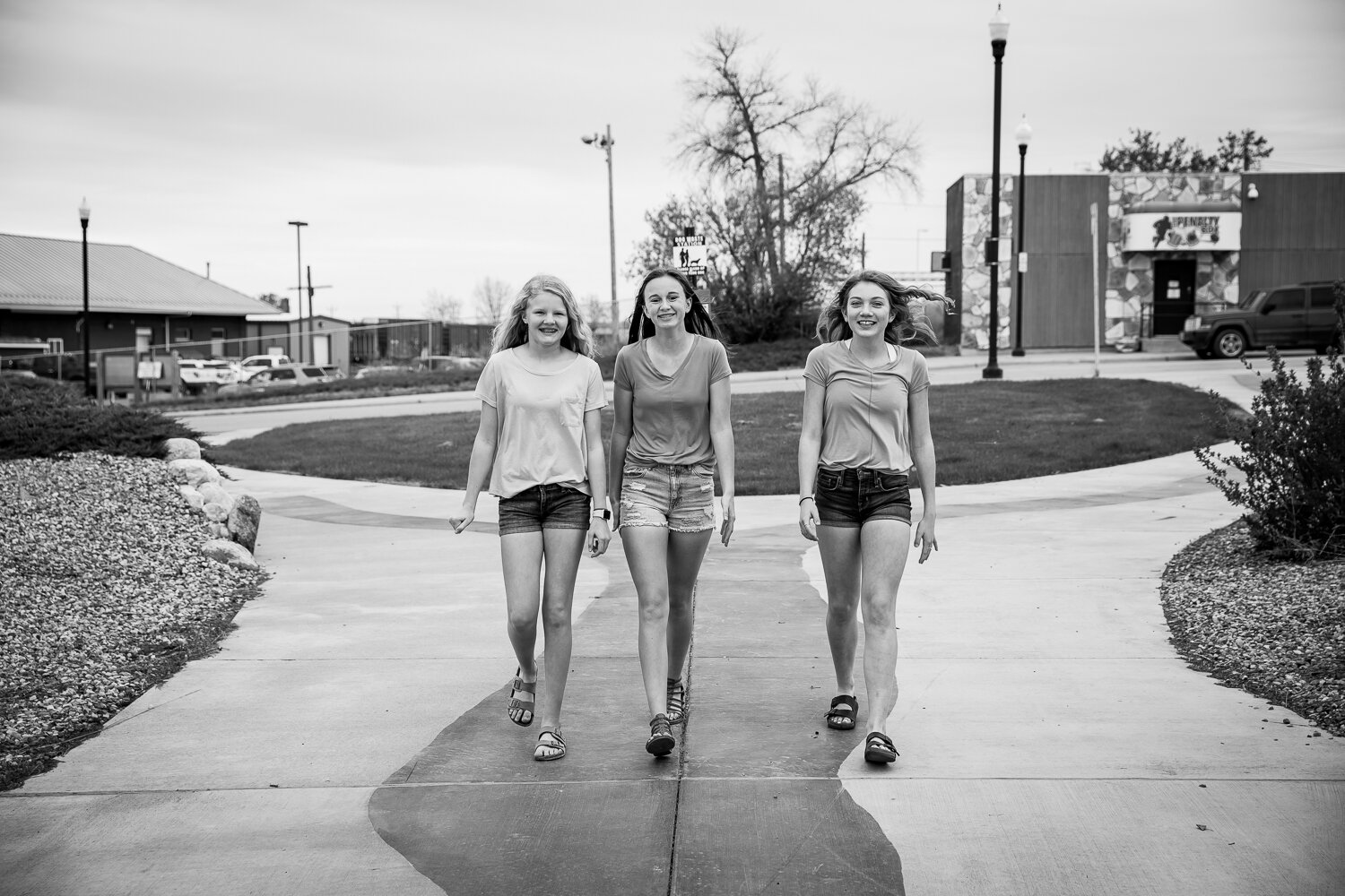 Black and white of 3 teen girls walking 