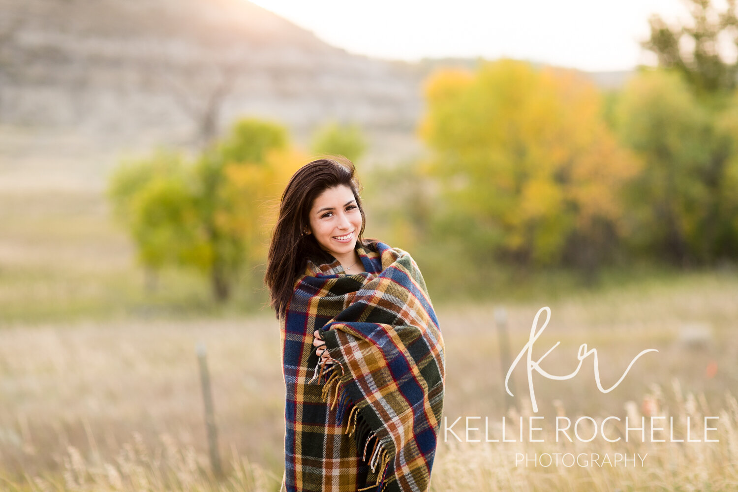 Fall backdrop and senior girl wrapped in blanket