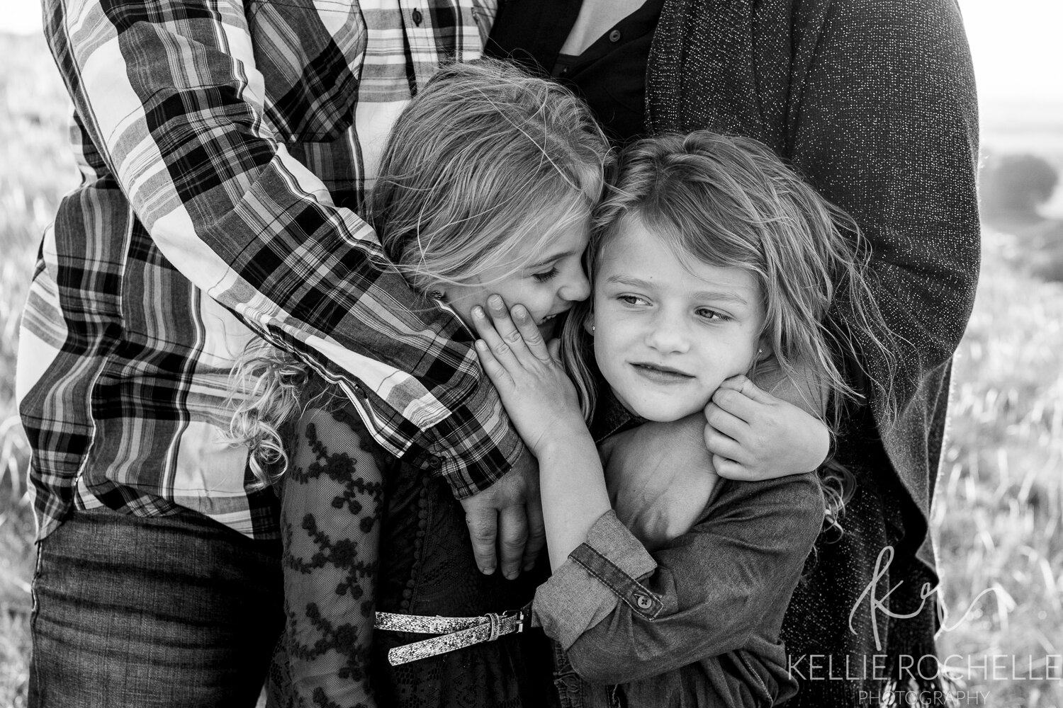 twin girls whispering in black and white