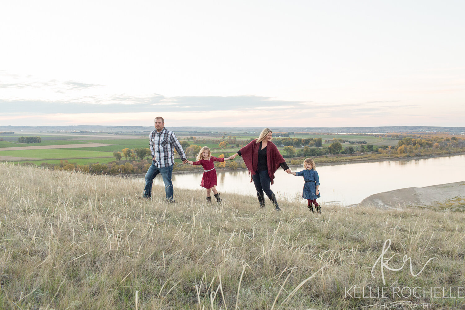 family walking together in nature wearing maroon colors in fall