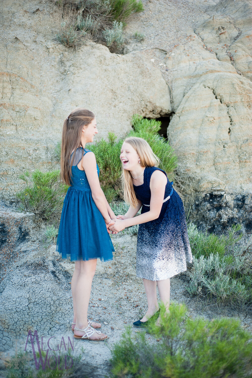 sisters holding hands and laughing