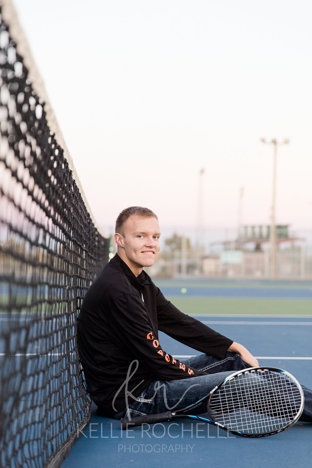 senior boy on tennis court