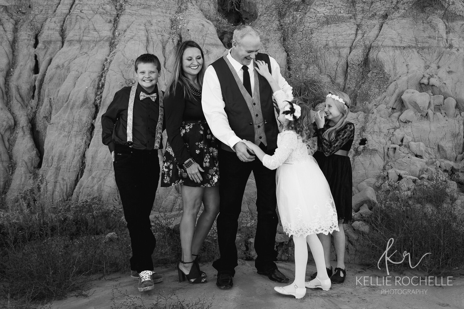family tickling in black and white
