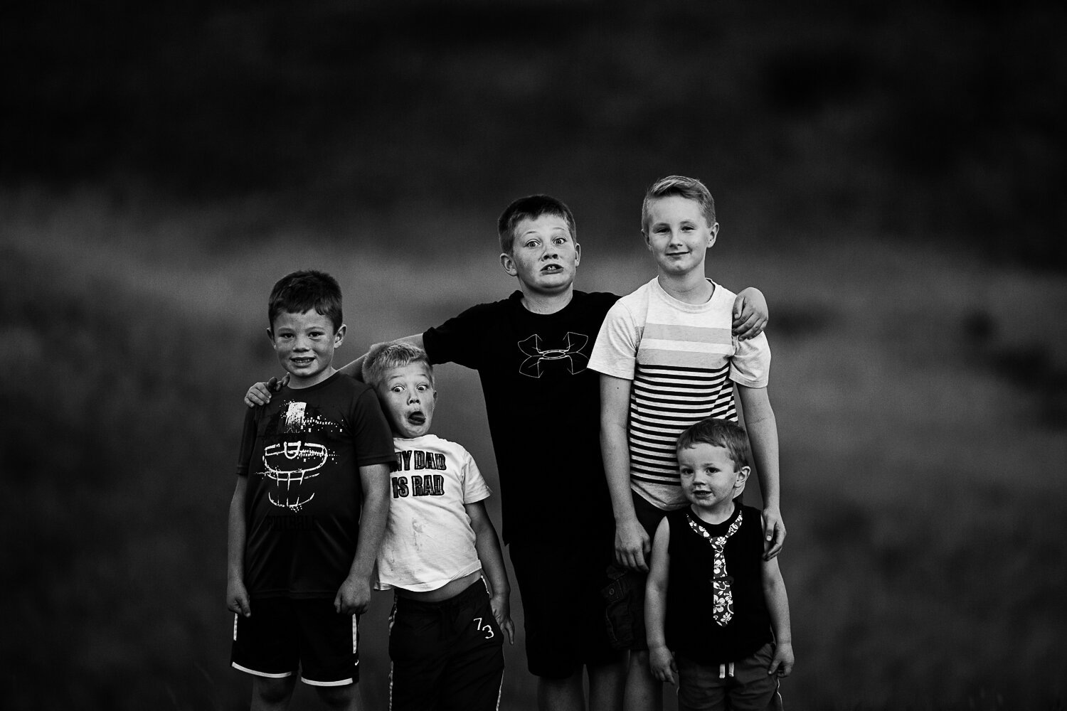 black and white of boys standing together funny faces- Williston portrait photography
