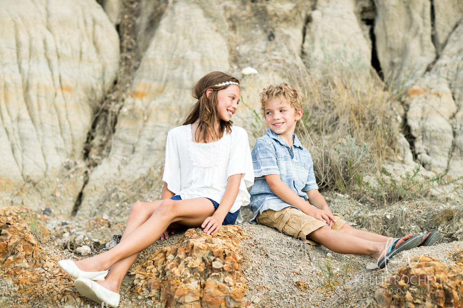 brother and sister on a rock