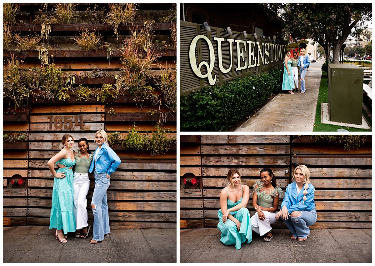 Three young women pose outside a Queenstown sign as part of a travel senior session with Kellie Rochelle Photography.