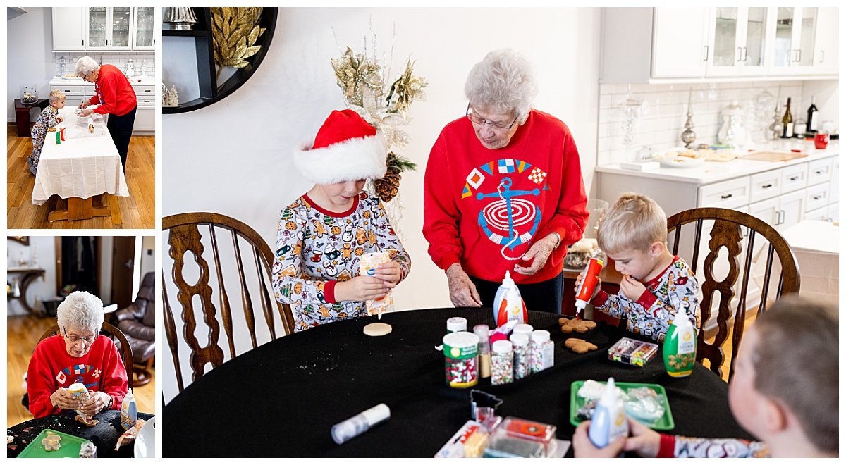 A grandmother in a festive, red sweatshirt decorates Christmas cookies with her three grandsons wearing cookie pajamas during an in-home family session with Kellie Rochelle Photography.