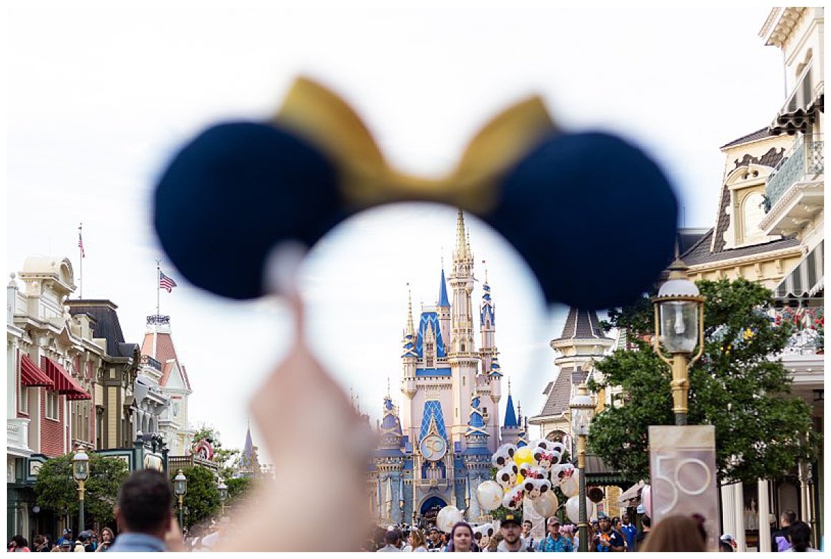 Cinderella's Castle at Magic Kingdom in Disney world comes into focus surrounded by Mickey Mouse ears.