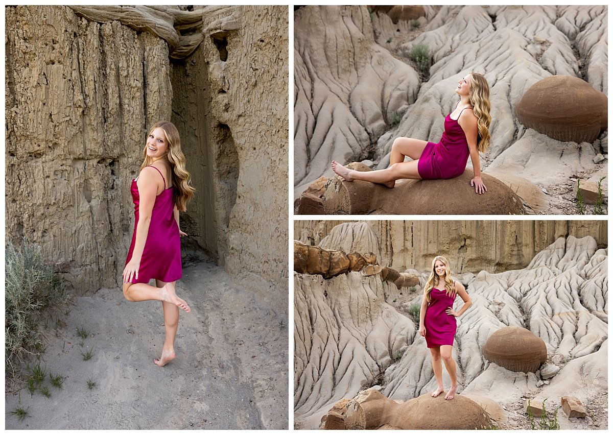 Wearing a spaghetti strap purple dress, a blonde high school senior poses on boulders at the base of a cliff in the North Unit.