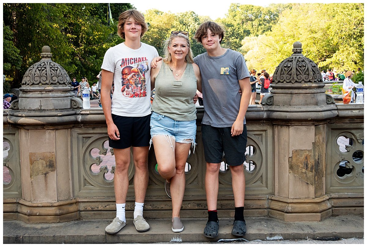 North Dakota photographer, Kellie Rochelle Photography, is pictured with her two teen sons leaned against an ornate barrier during a trip to NYC.