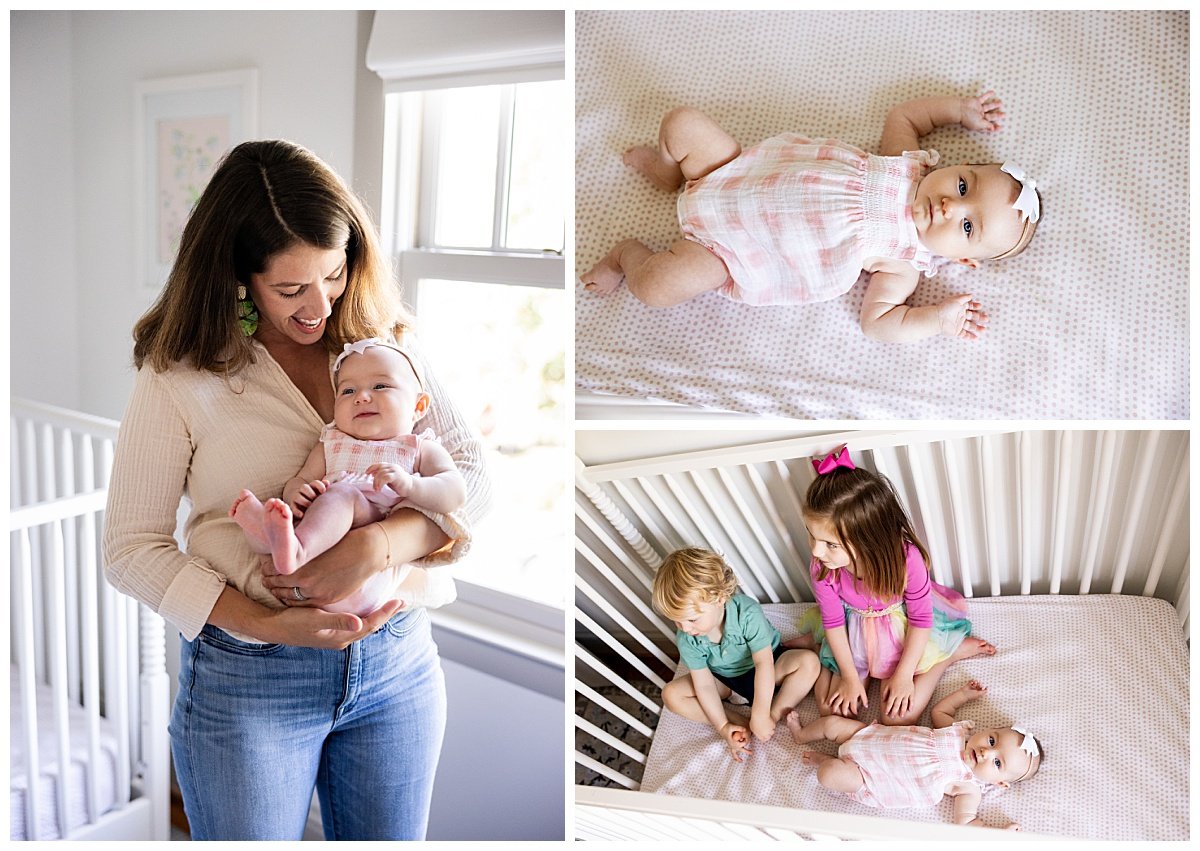 A mother with dark, shoulder length hair holds her baby girl wearing pink gingham in a naturally lit nursery with her older siblings during an in home family session. 