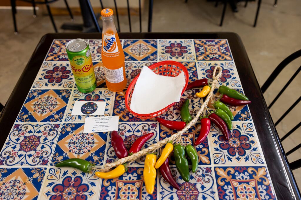 Food prepared by La Cocina Taqueria is featured atop a colorful tiled table during a woman-owned business branding session with Williston ND photographer, Kellie Rochelle Photography