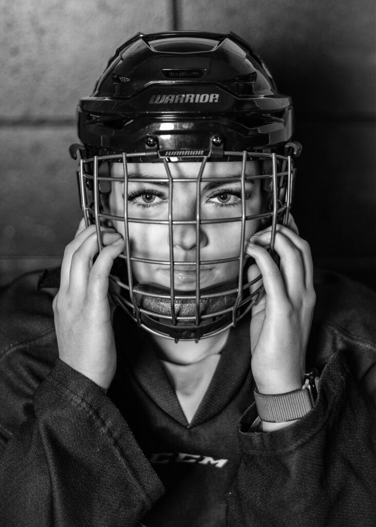 A black and white North Dakota senior hockey player photo is displayed from a senior photoshoot with Kellie Rochelle Photography.