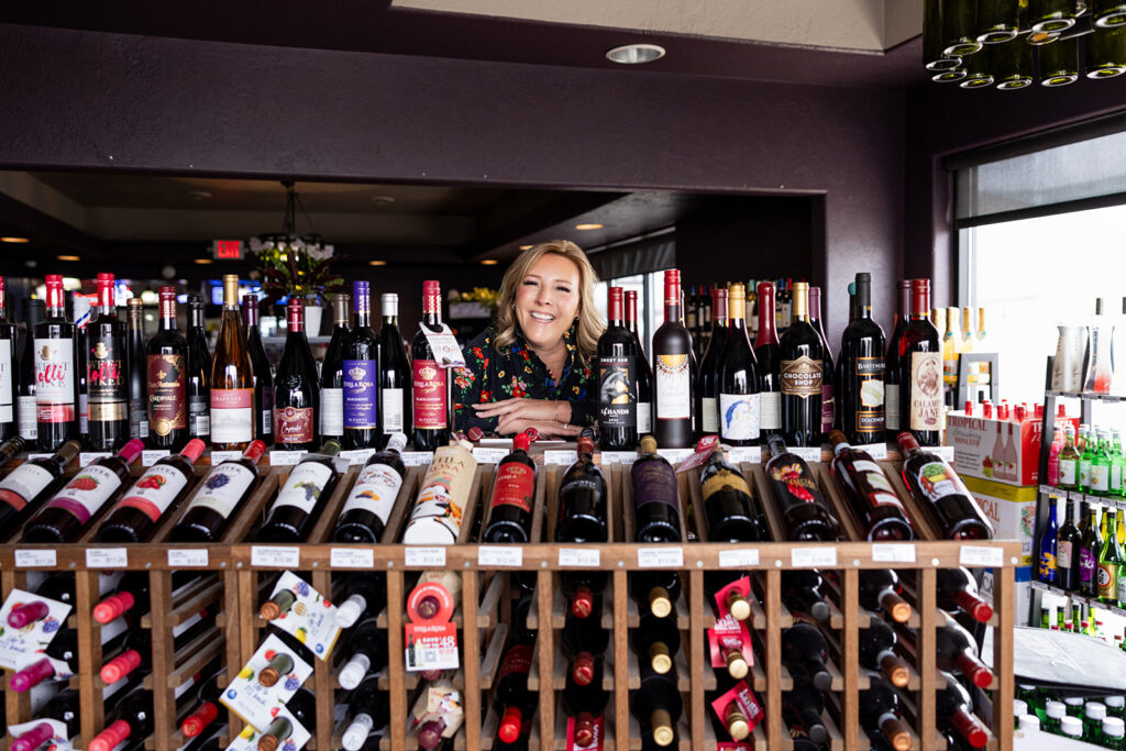 A wide variety of wines available for purchase at locally owned and operated  Williston, ND liquor store, 26th Street Liquor, along with the owner, Sheila Goehring as part of a brand session with Kellie Rochelle Photography.