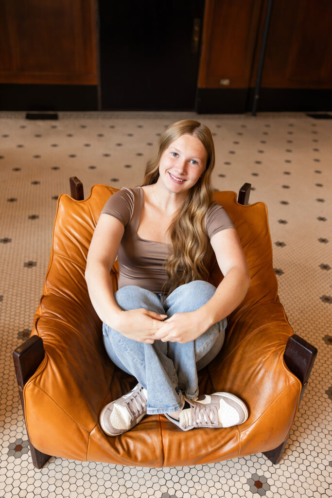 A blonde high school senior is seated in a leather chair in the lobby of the Clyde Hotel in downtown Portland.