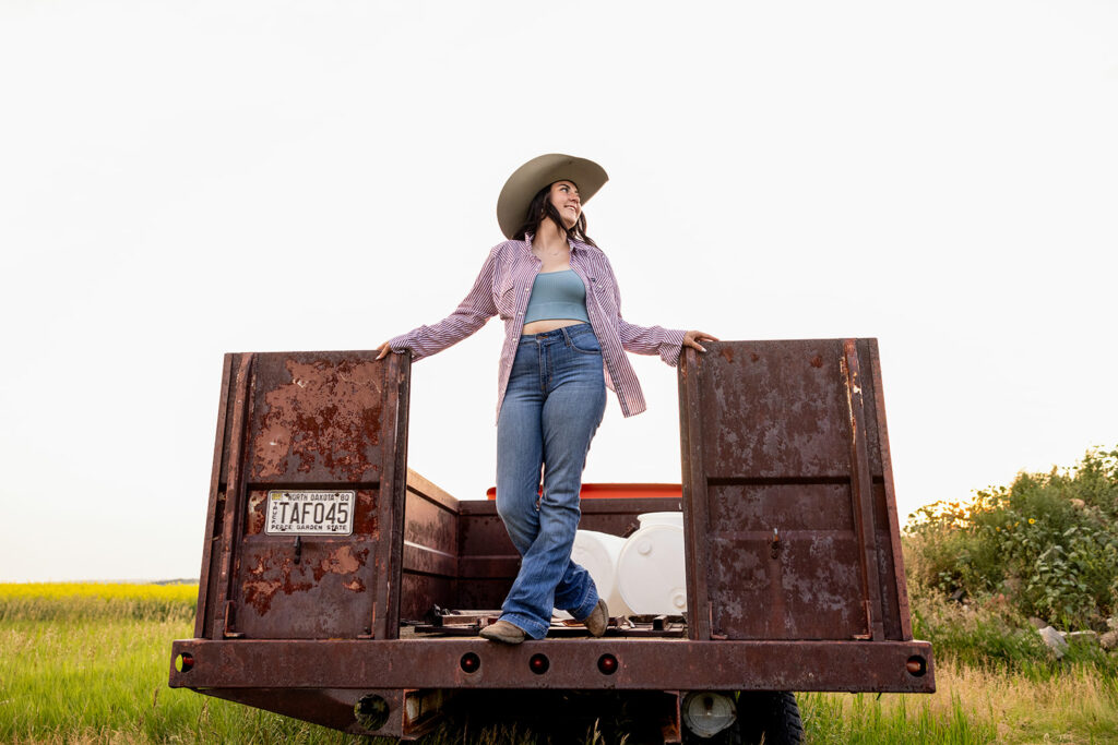 Cami Standing in a pick-up tailgate 