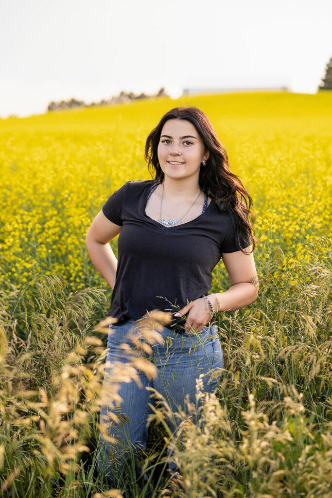 Cami standing in a canola field. 