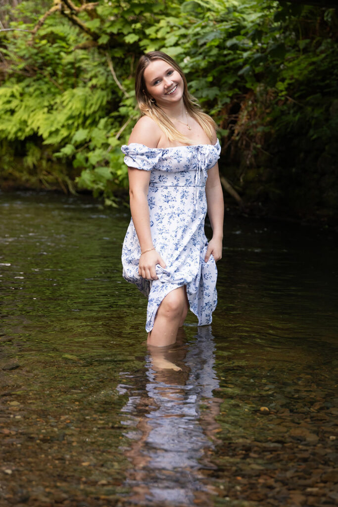 Sam wearing a peasant-style dress with blue flowers at the Oregon Coast