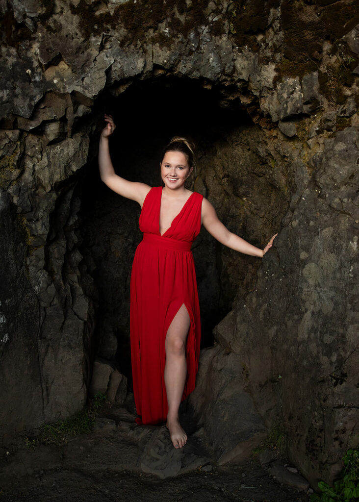 Senior photo of Sam in a flowing red dress at Multnomah Falls