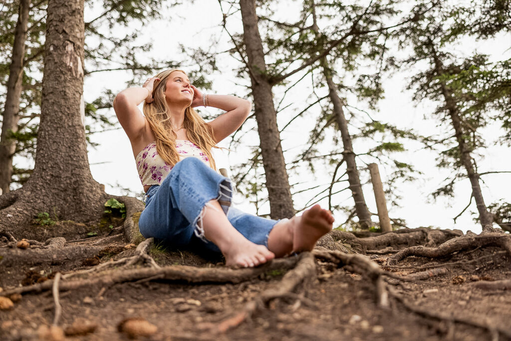 Kaitlyn posing at Devil’s Cauldron, capturing dramatic coastal scenery for her senior travel photography session