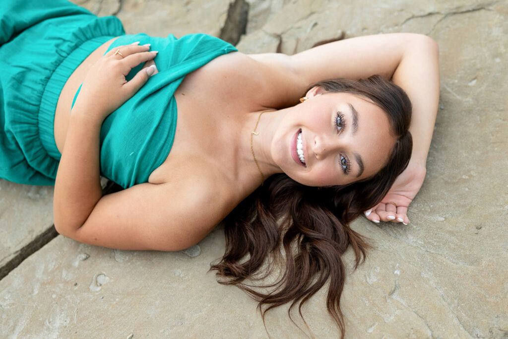 Natural and candid senior portrait of Jayla laughing at golden hour, showcasing her personality.