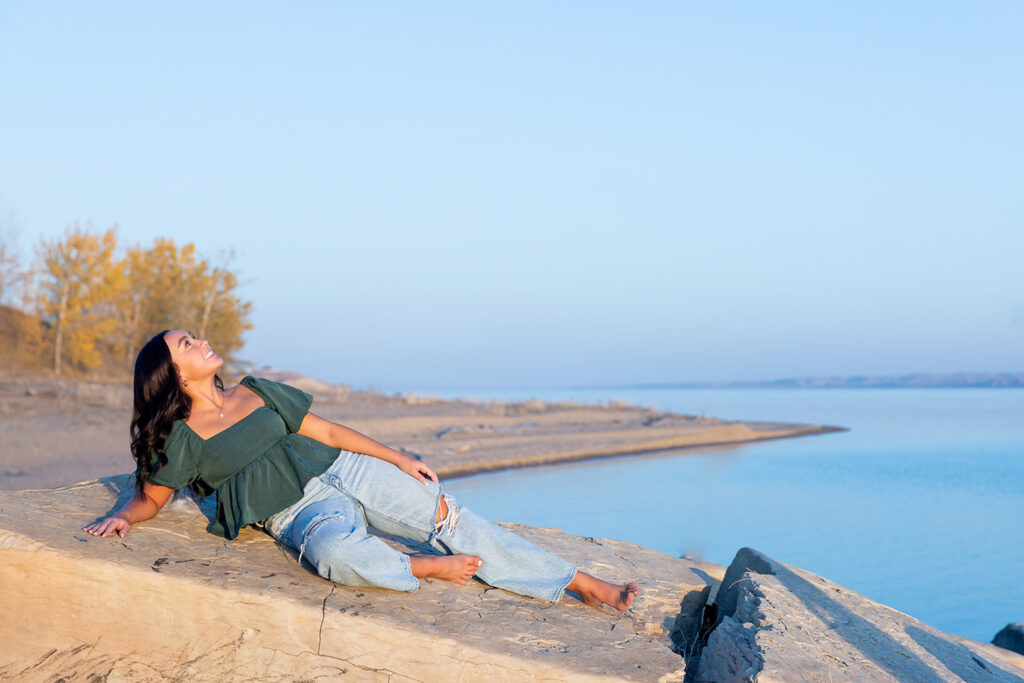 Lake Sakakawea senior portraits with Jayla at sunset, featuring a soft and dreamy lake backdrop.