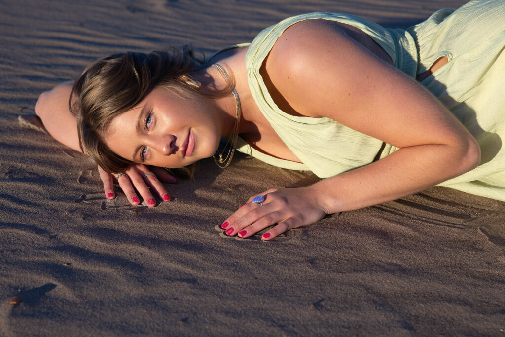 A class of 2025 senior photo taken at St. Anthony Sand Dunes during a destination senior session by Kellie Rochelle Photography