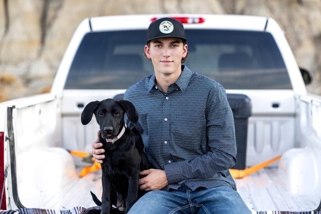 Close-up of Hudson smiling with his puppy in his arms