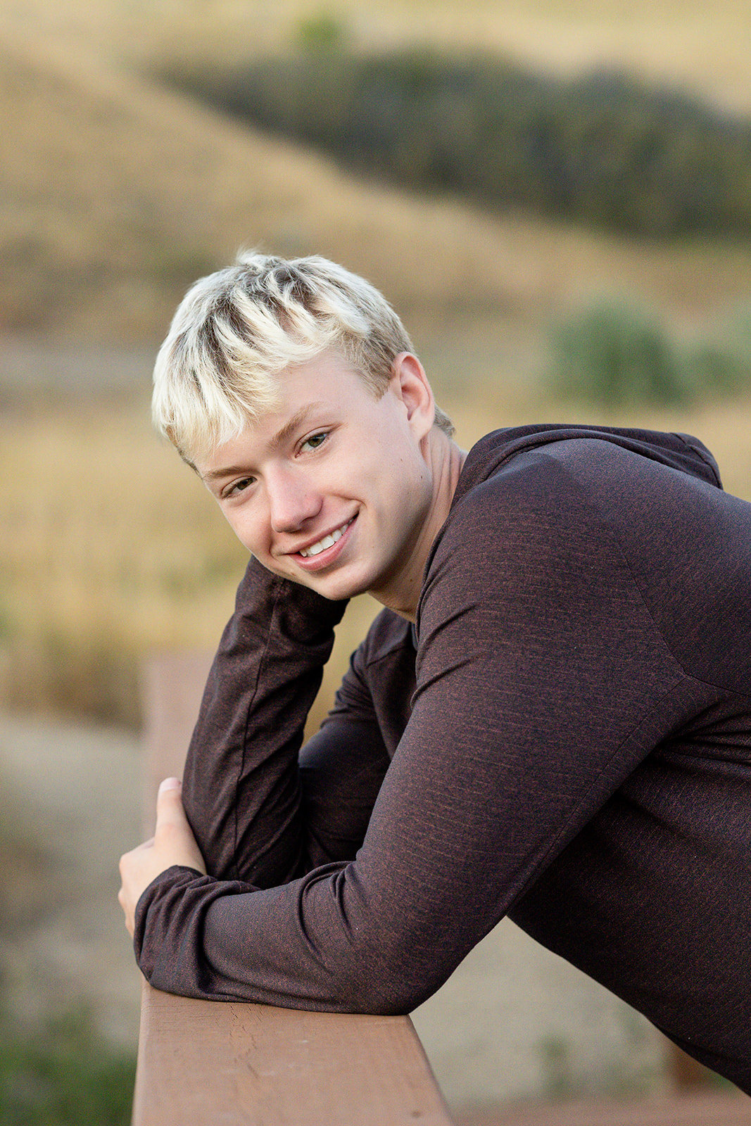 Senior boy leaning against railing