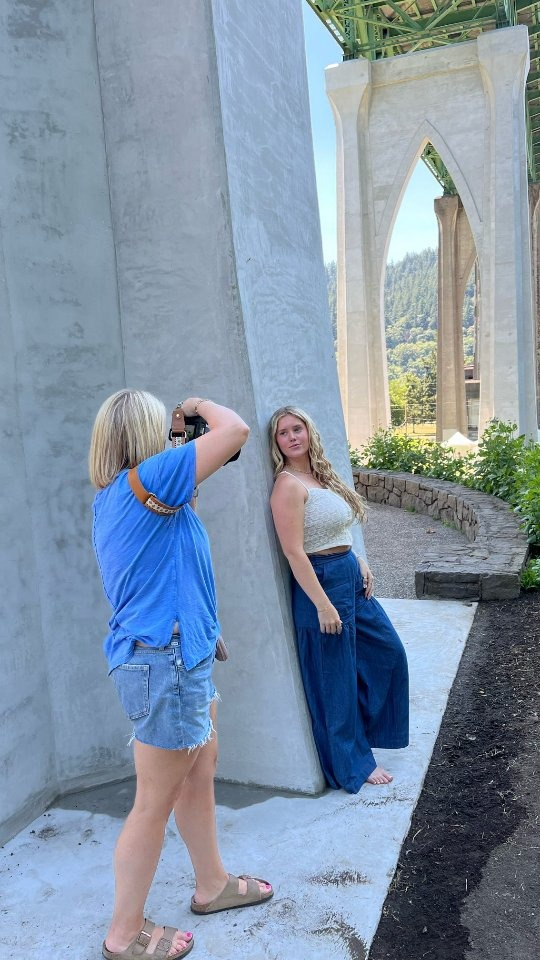 a photographer wearing a blue shirt photographing a client