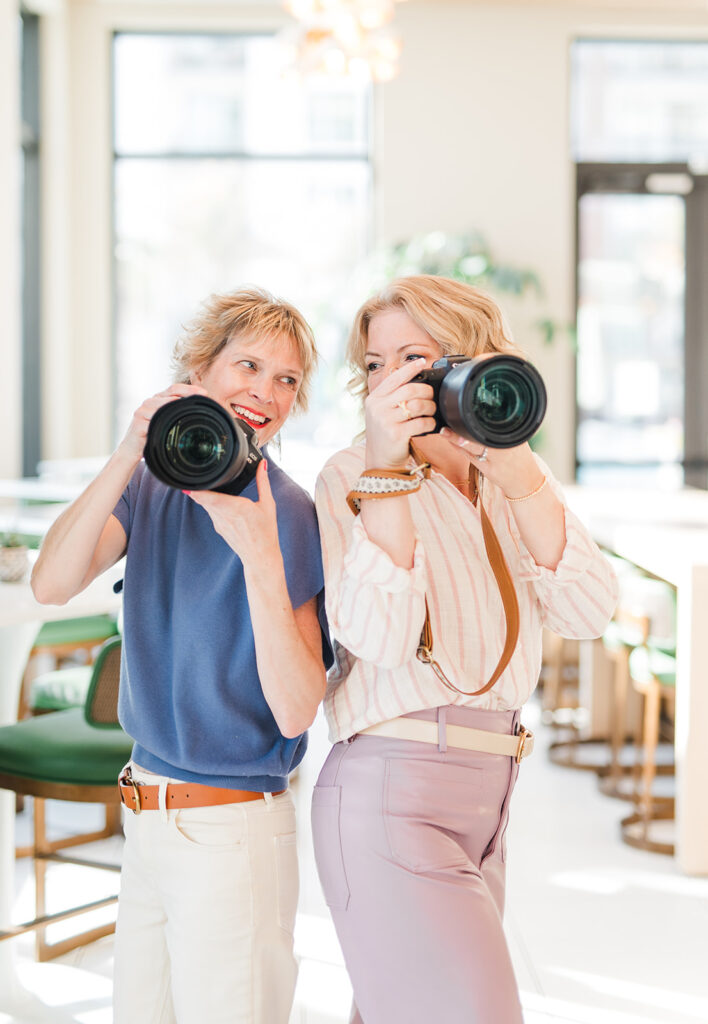 two photographers with their cameras at a branding session 