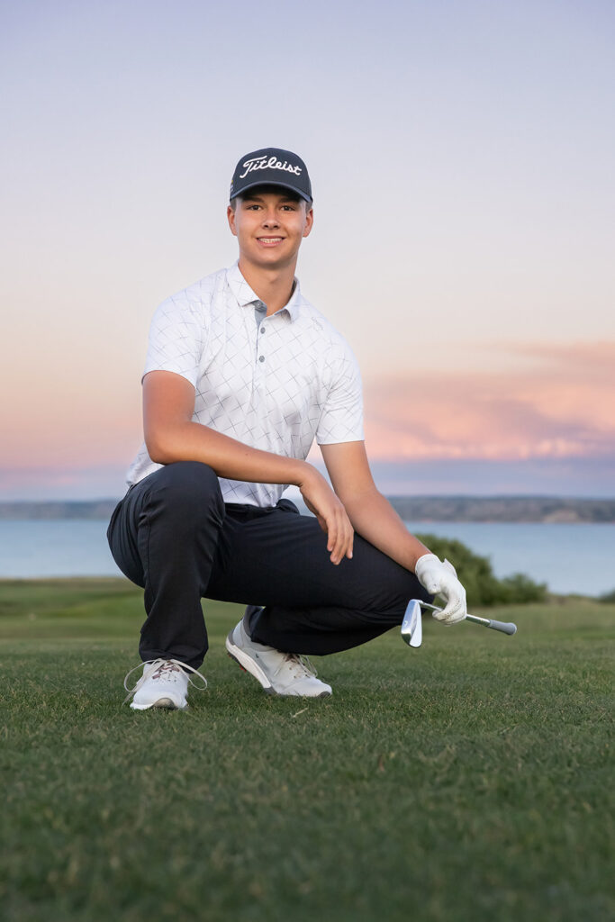 A high school golfer poses on the green during a session with North Dakota senior photographer, Kellie Rochelle Photography 