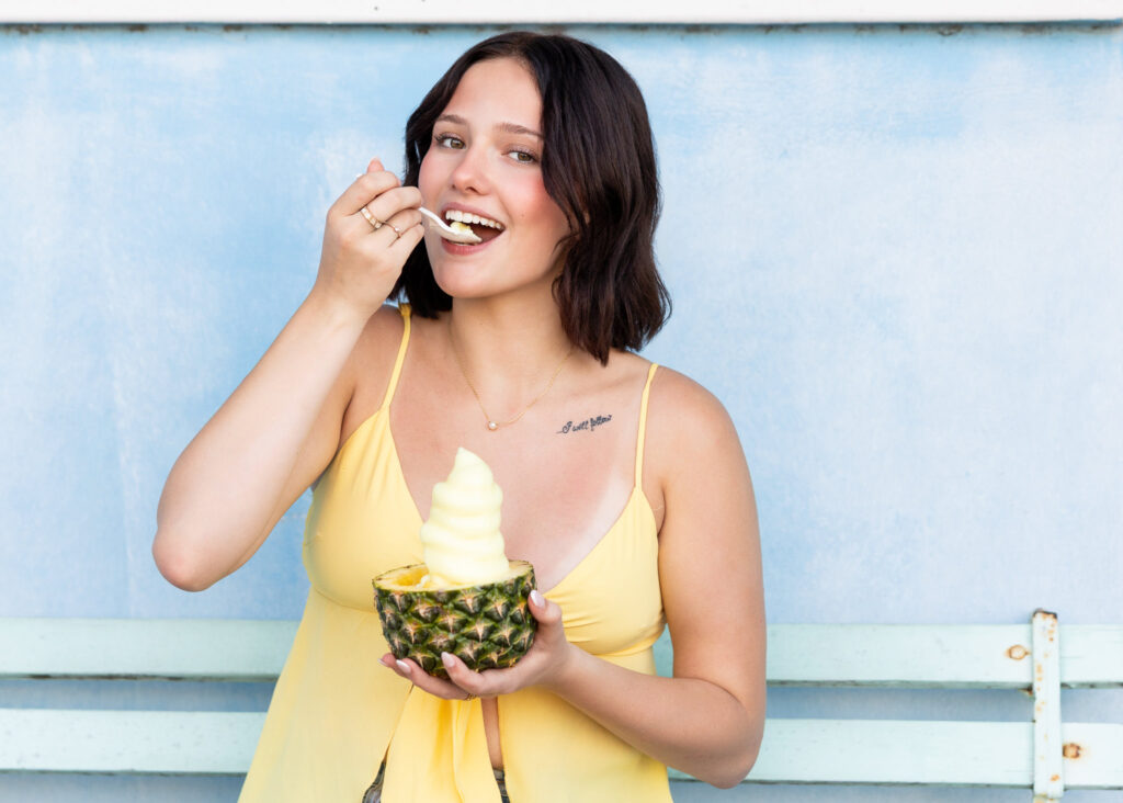 Casual senior portraits eating ice cream in downtown Folly Beach
