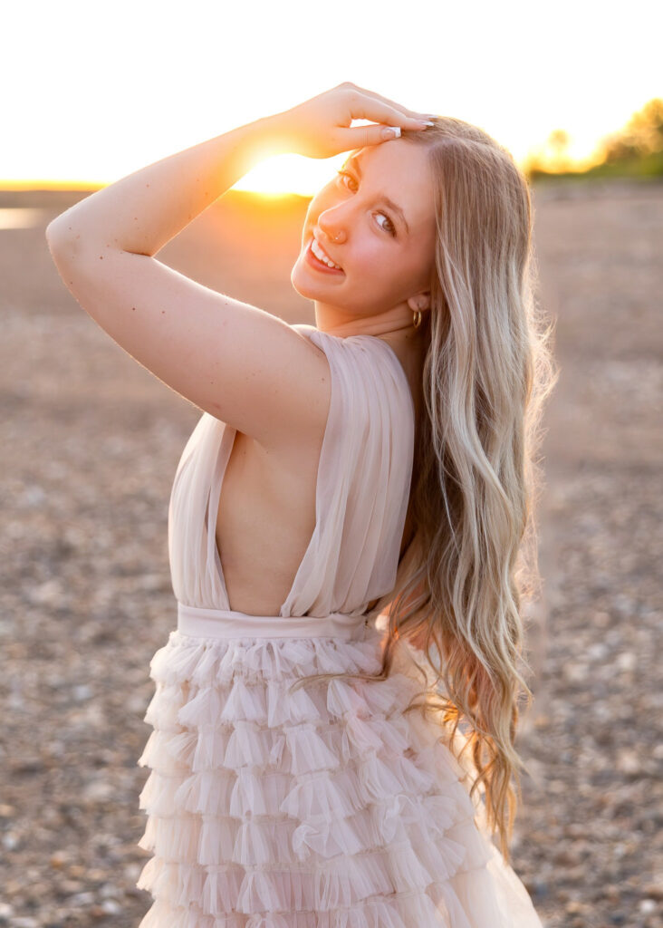 Senior girl in soft tulle dress with flowing hair, captured before noticing subtle client red flags.