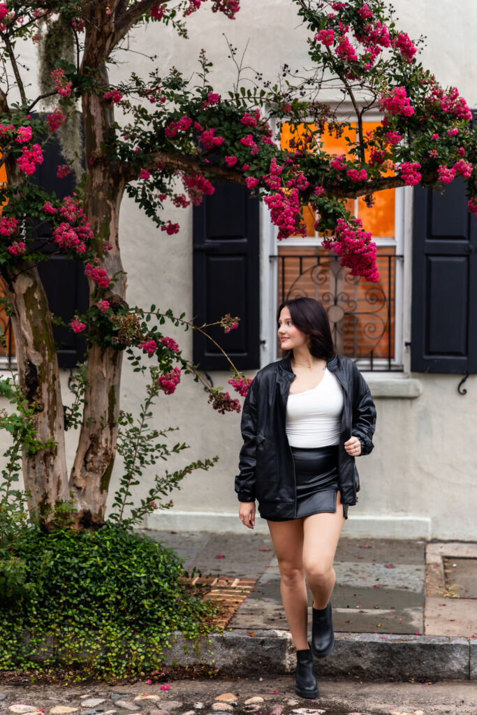 Walking shot on cobblestones during Charleston senior session on Chalmers Street
