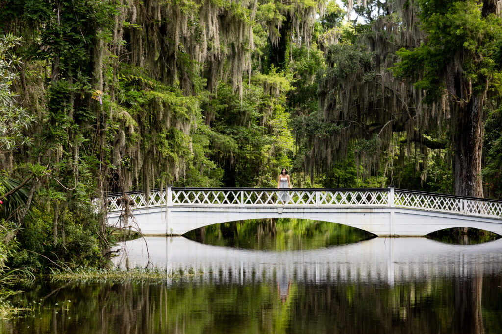 Senior girl on a moss-covered bridge at Magnolia Plantation in Charleston
