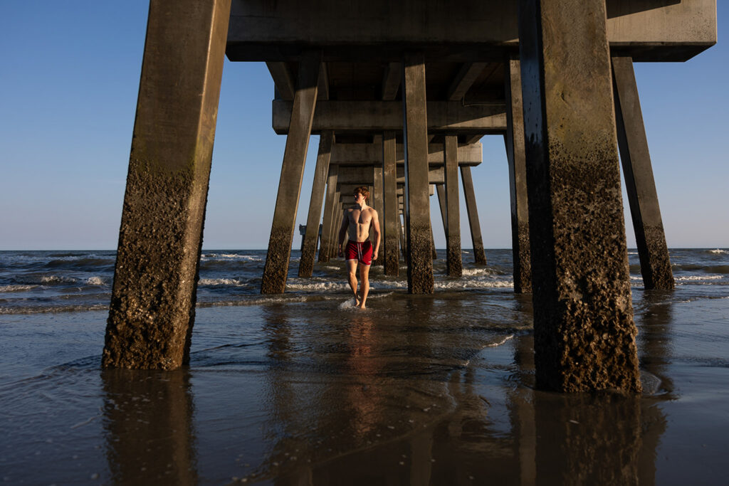 Barefoot senior session on the shoreline at Folly Beach in Charleston
