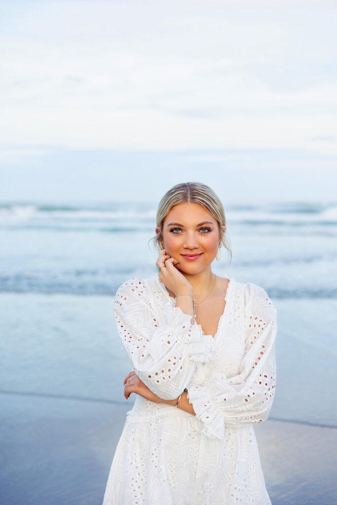 A high school senior poses for senior photos at one of the beaches near cape coral fl