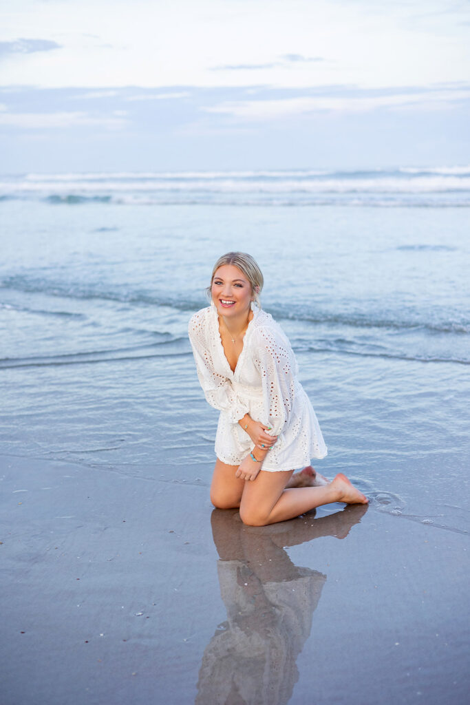 While on a cape coral florida vacation, a young woman poses for senior photos