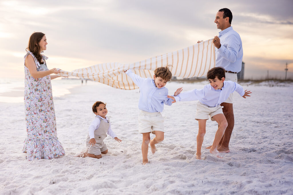 A family of five laugh during a family photoshoot while on a cape coral florida vacation
